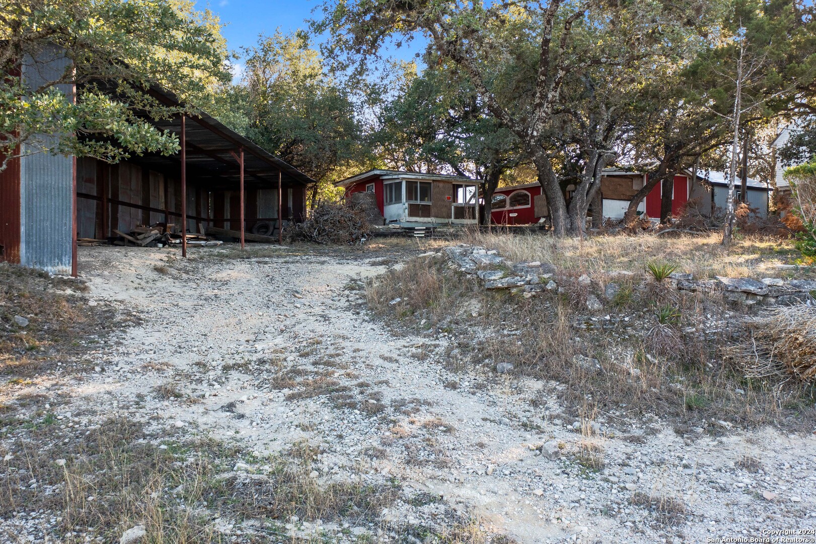 a view of a house with a yard and tree s