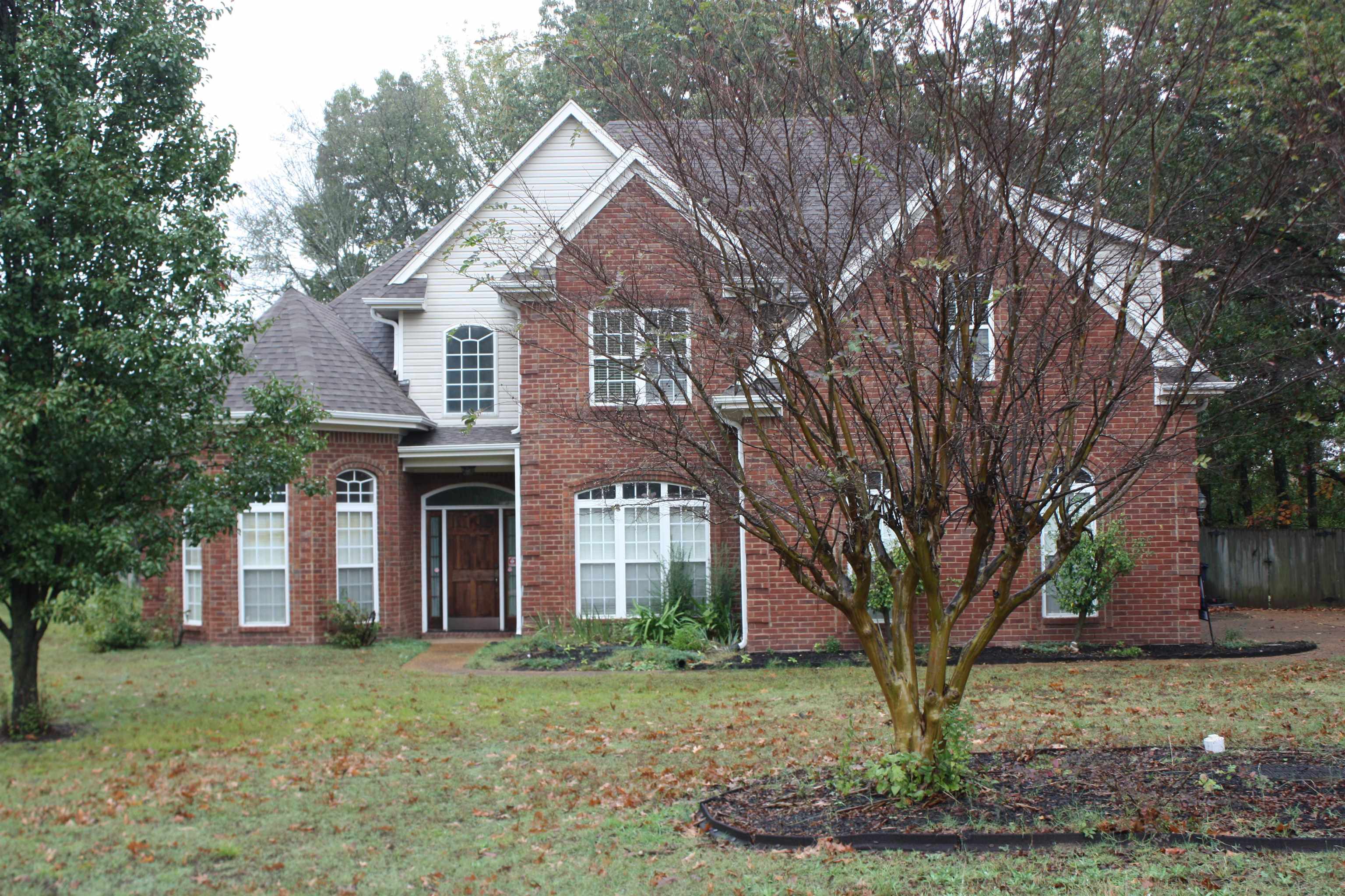 View of property with a front yard