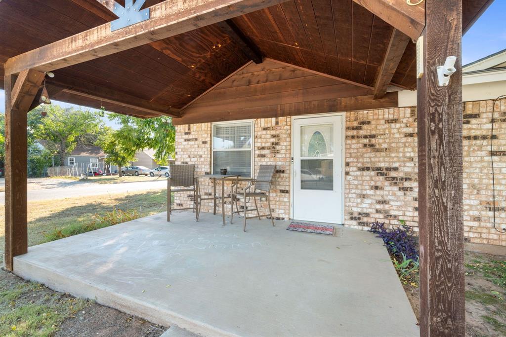 a view of a porch with chairs and backyard