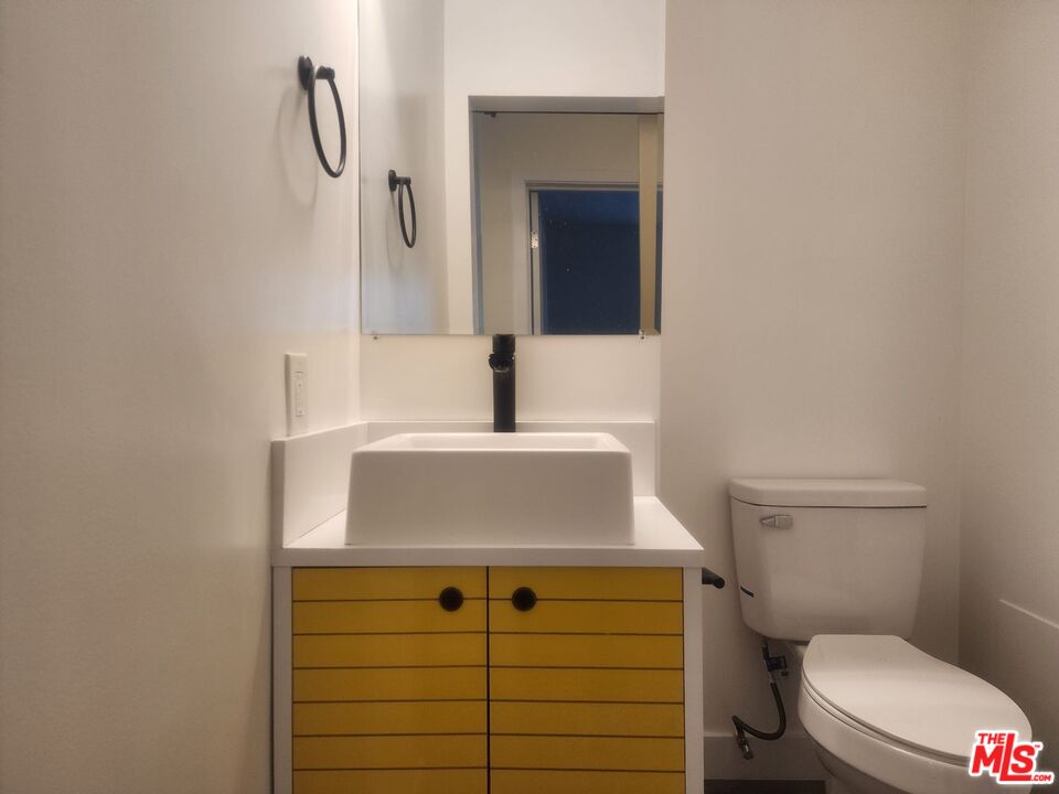 a bathroom with a sink toilet and mirror