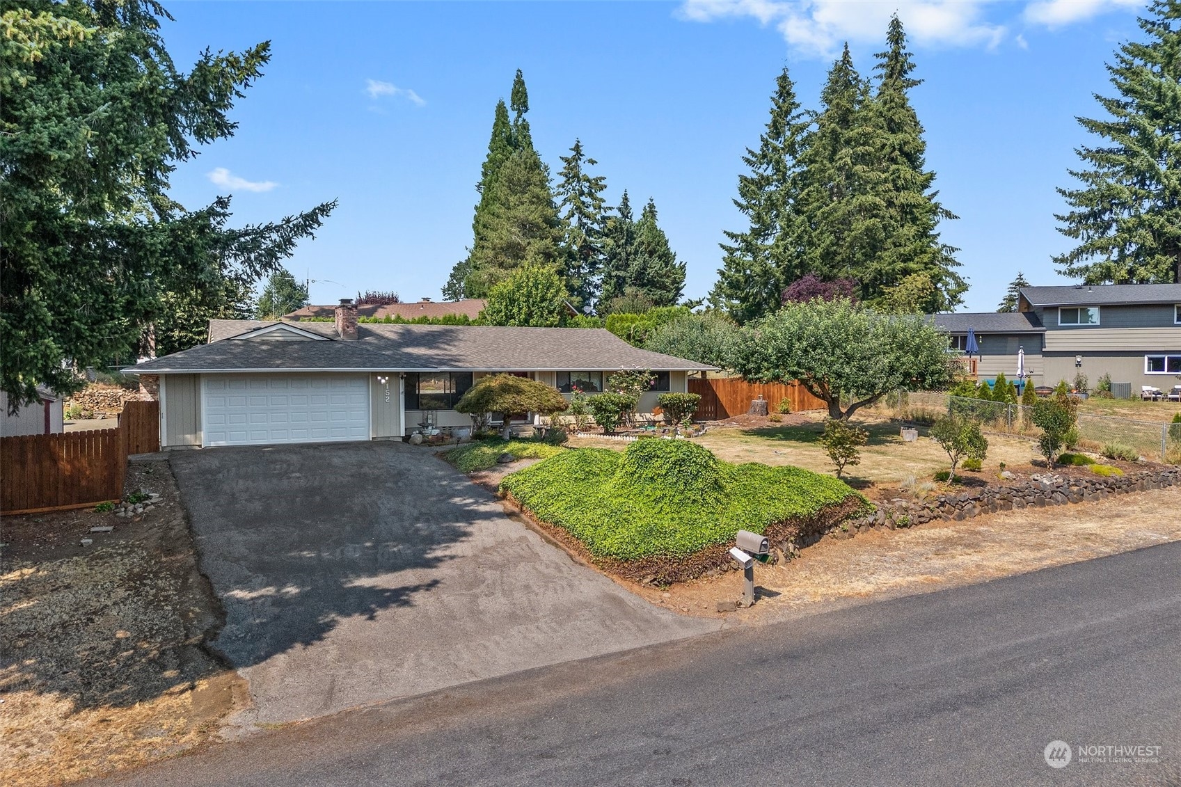 a view of a house with a yard and garage