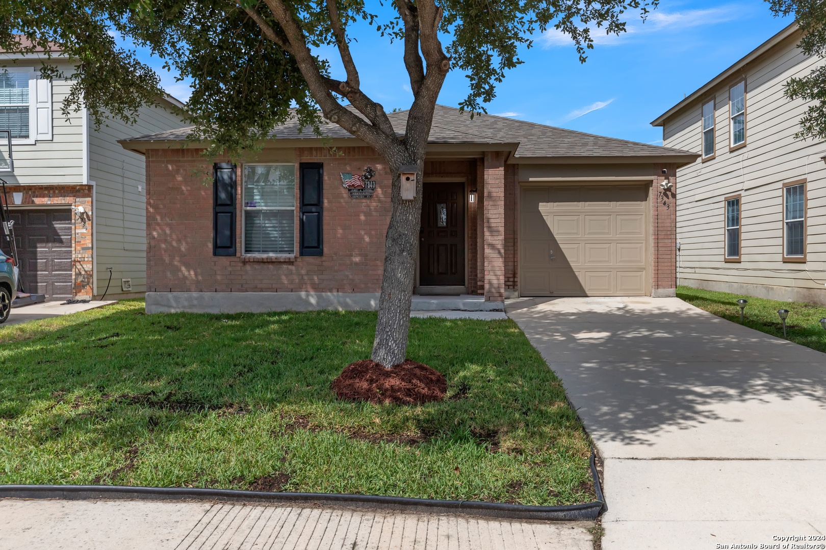 a front view of a house with a yard and garage