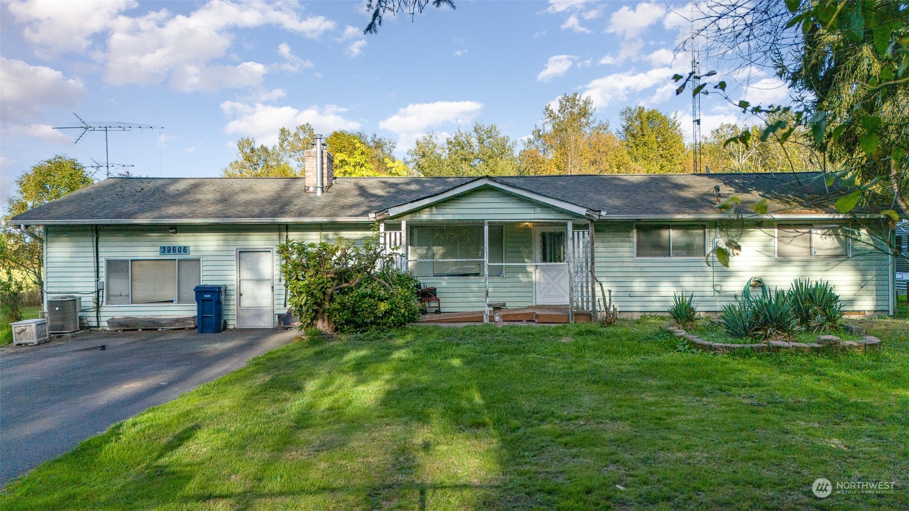 a front view of a house with a garden and plants