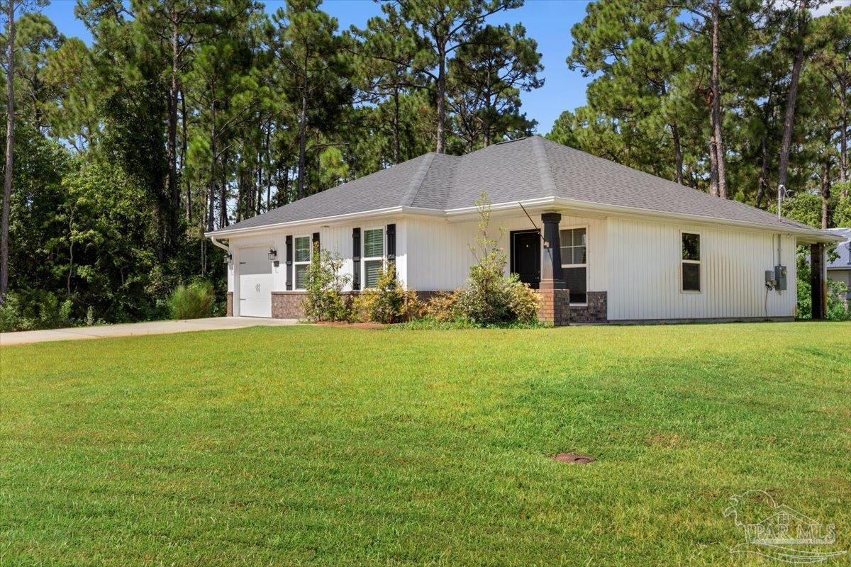 a front view of house with yard and green space