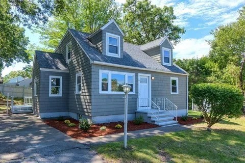 a front view of a house with a yard