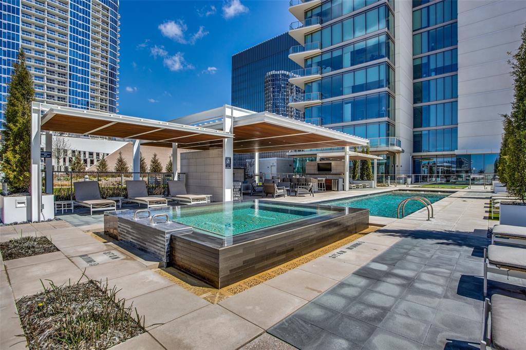 a view of a swimming pool with sitting area in front of it