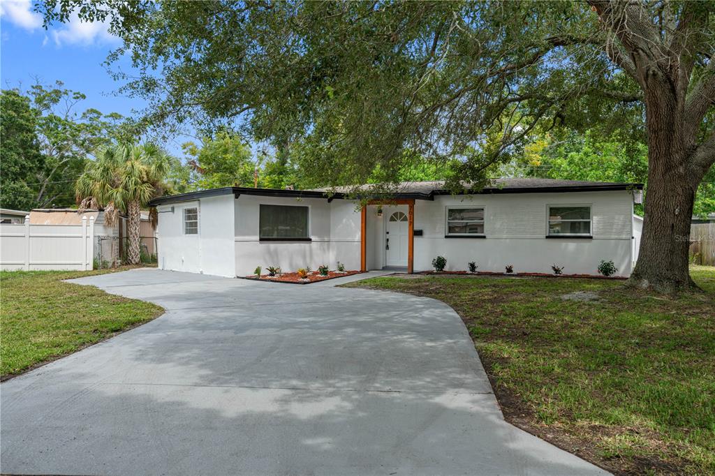 a front view of house with yard and trees