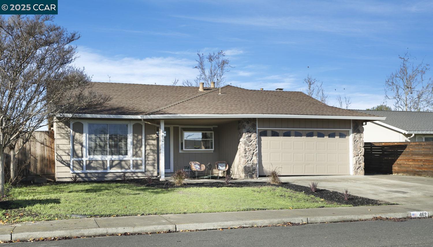 a front view of a house with a garden