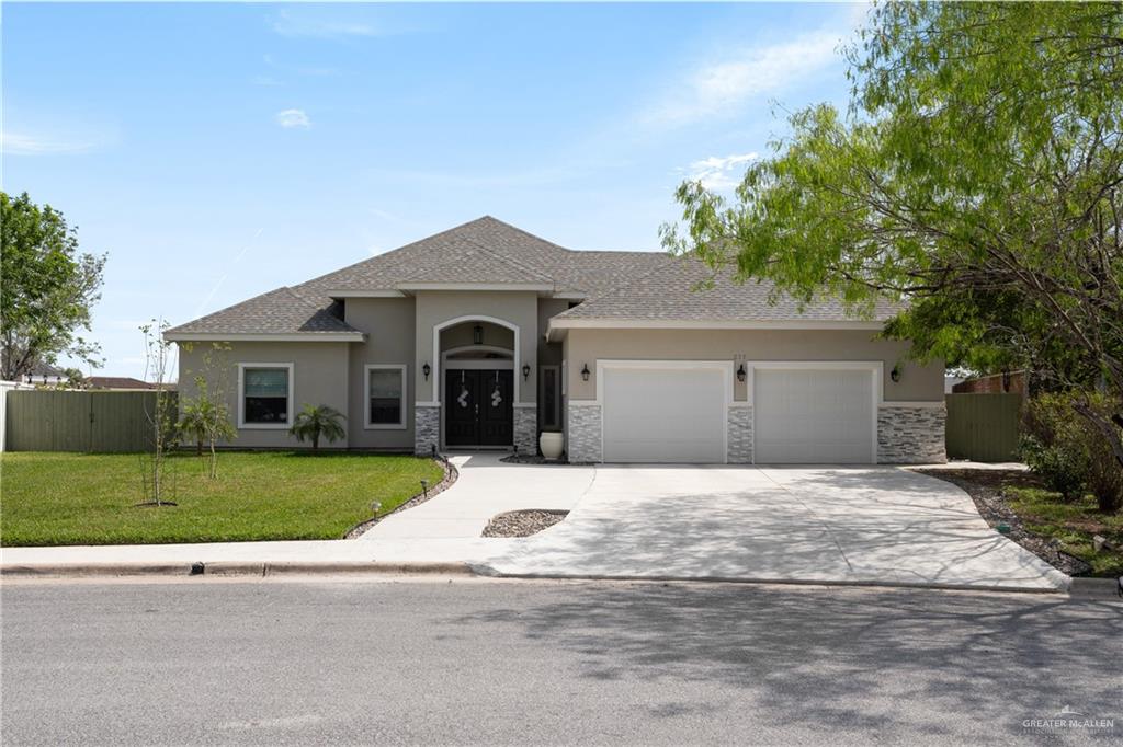 a front view of a house with a yard and garage