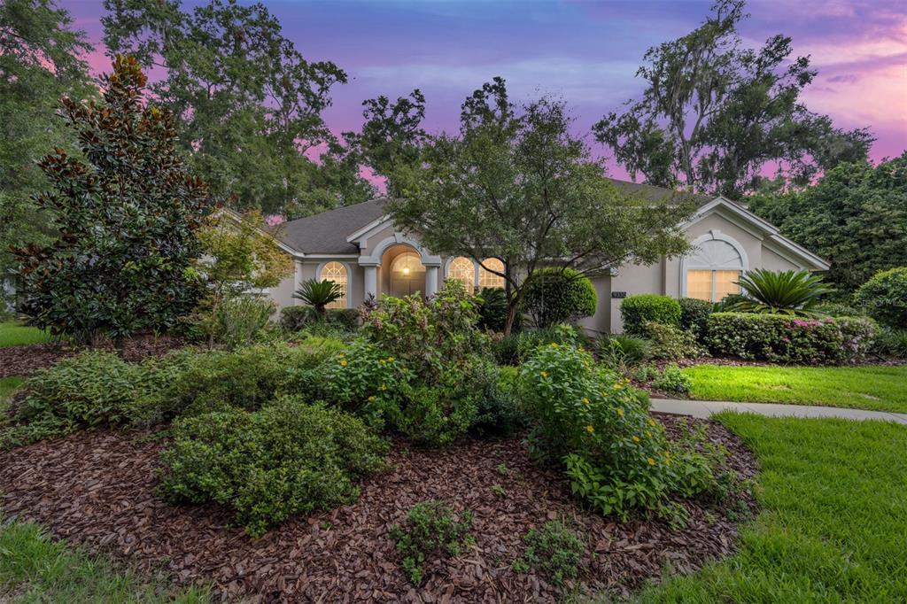 a view of a house with a yard and garden