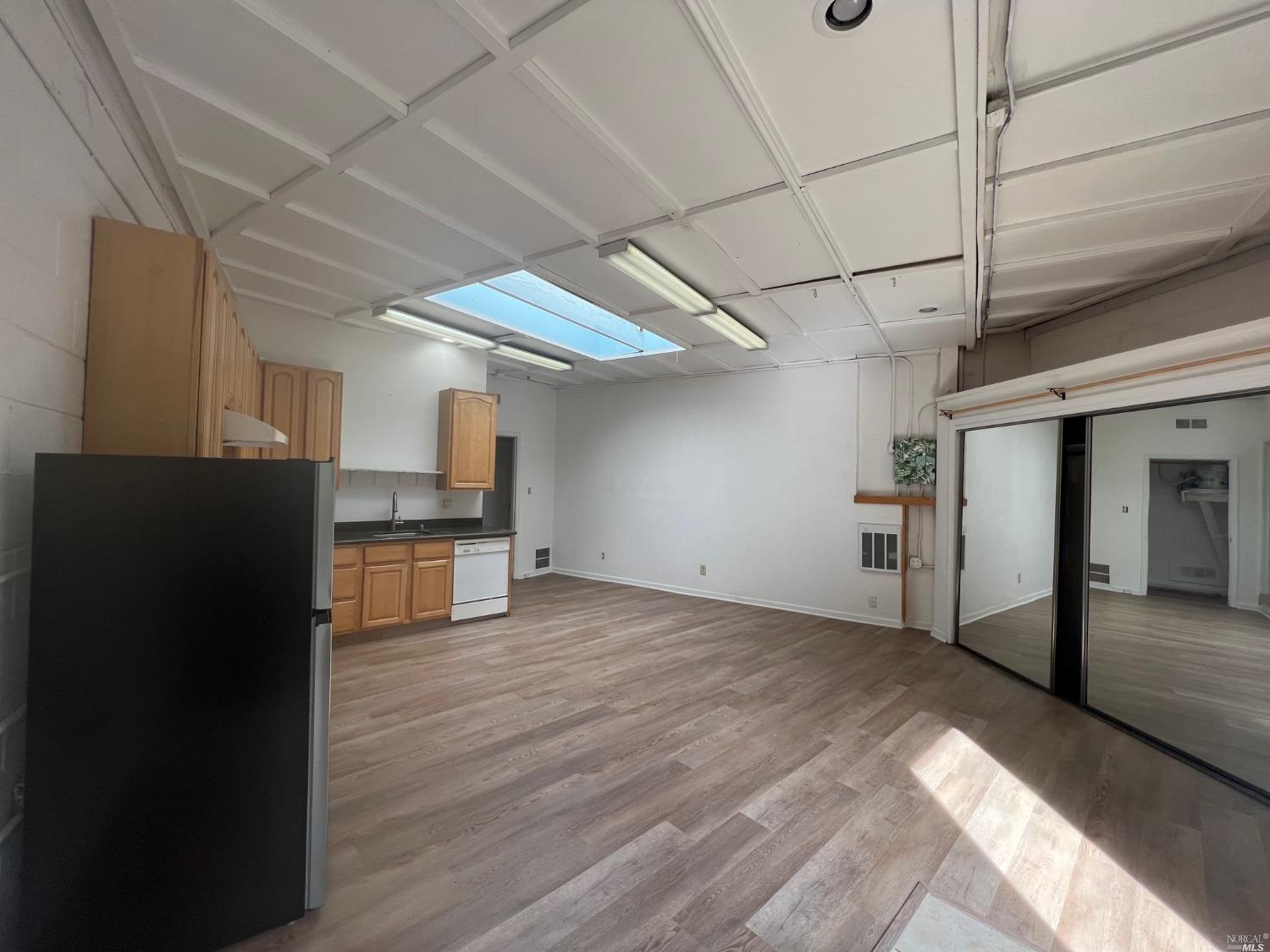 a view of a kitchen with a sink and a refrigerator