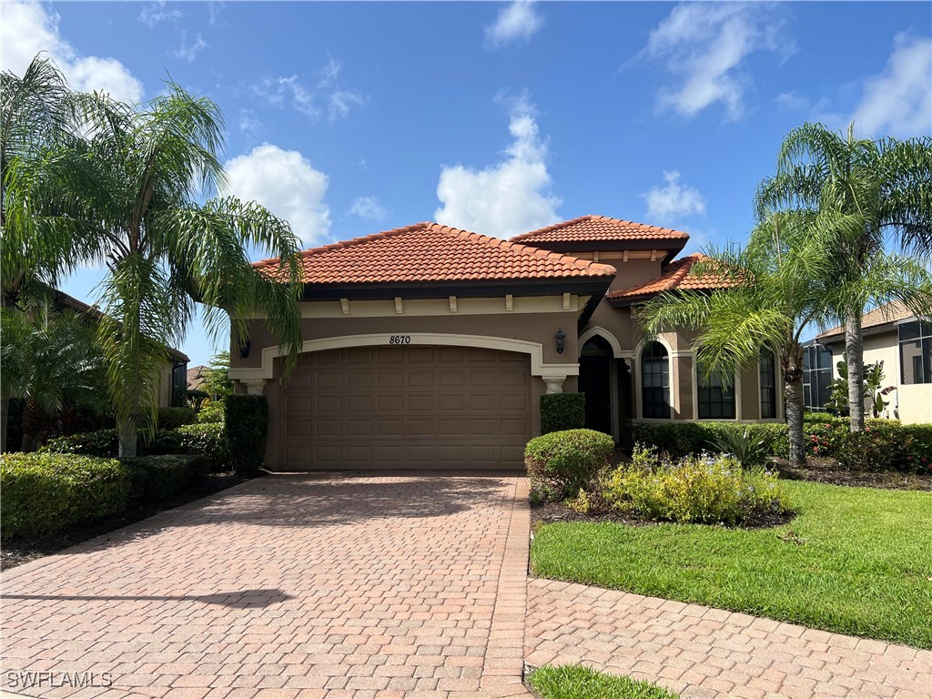 a front view of a house with a yard and garage