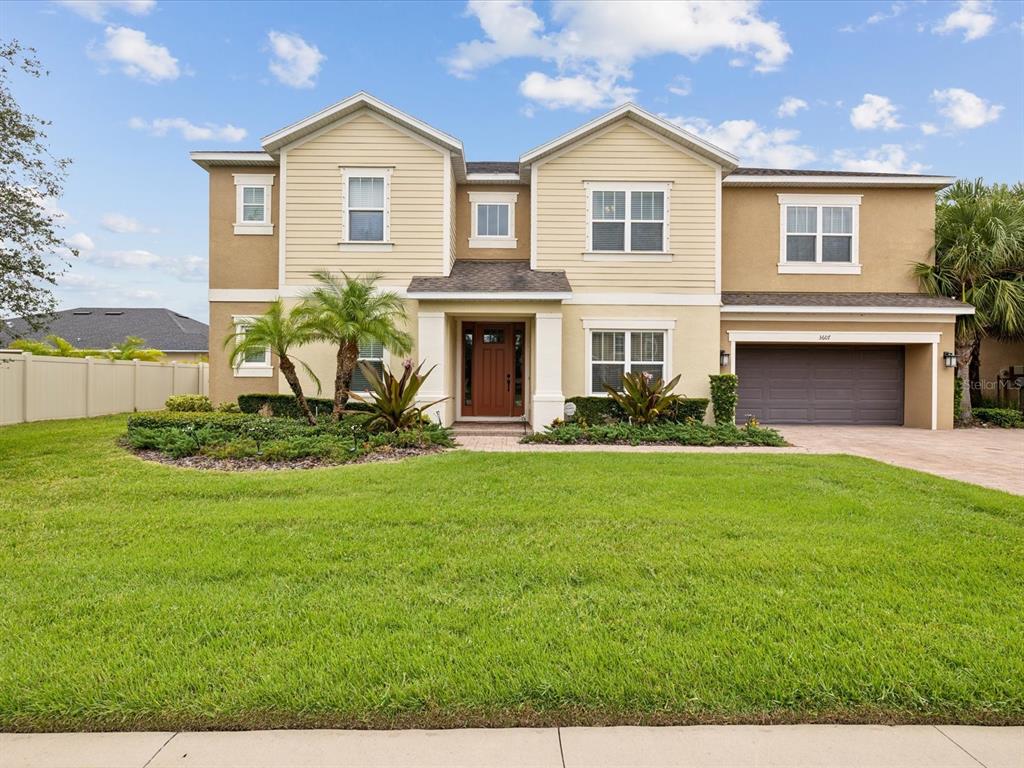 a front view of a house with a yard and garage