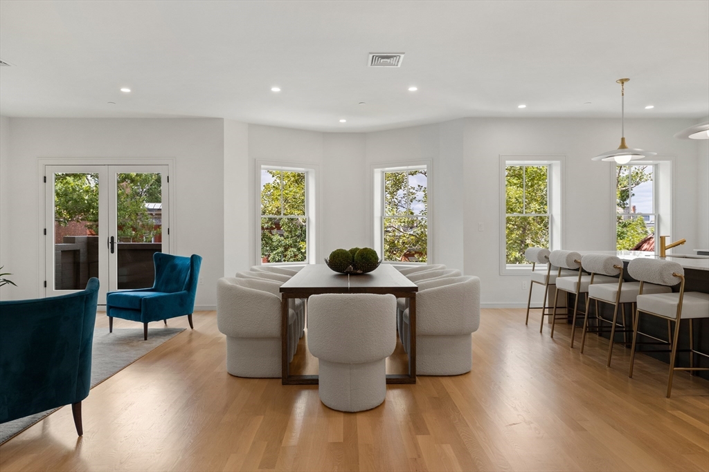 a living room with furniture a wooden floor and potted plant