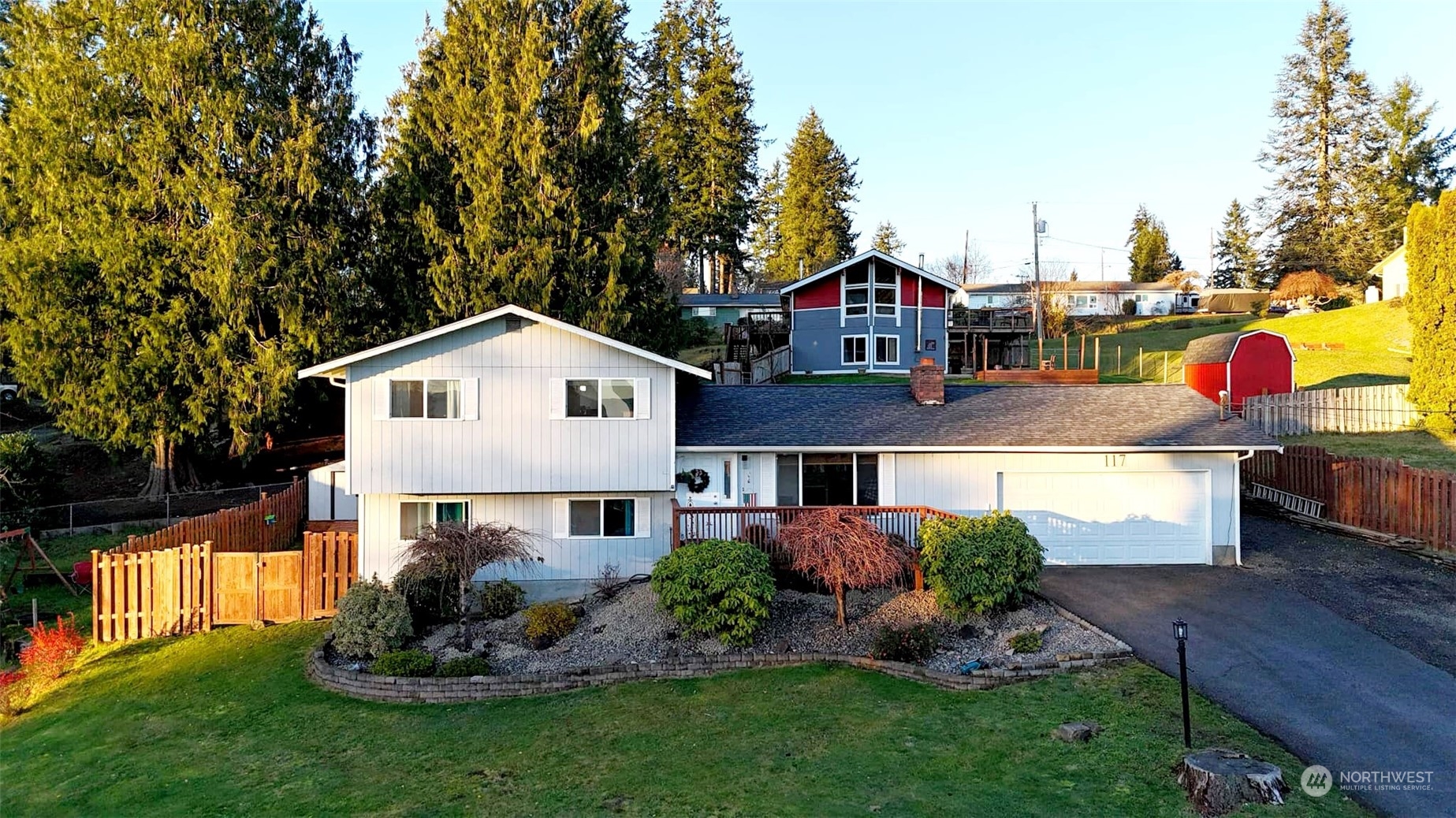 a front view of a house with a yard and trees