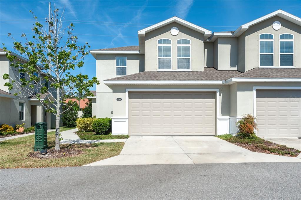 a front view of a house with a yard and garage