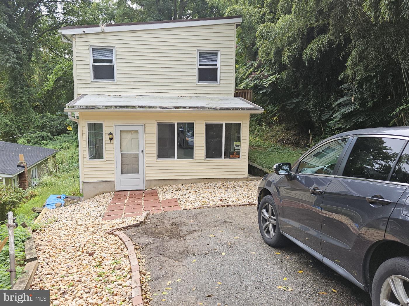 a front view of a house with parking space