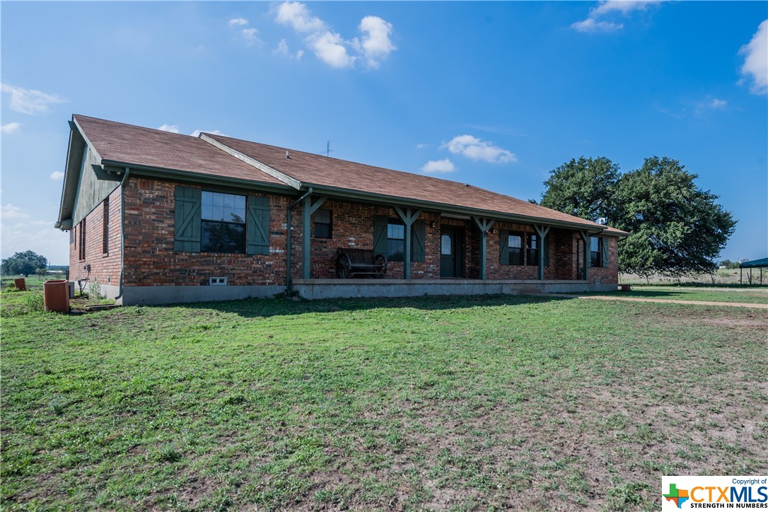 a view of a house with backyard porch and garden