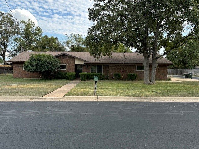 a house that has a tree in front of it