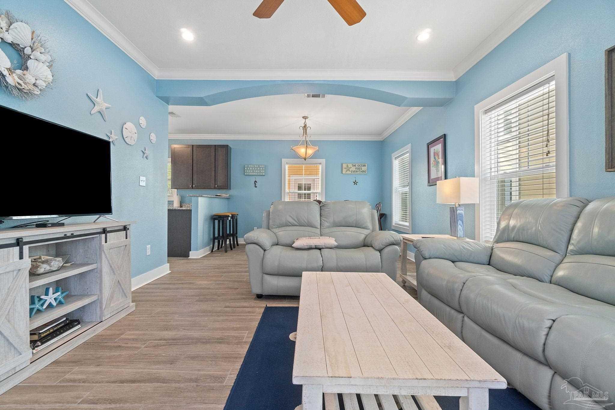 a living room with furniture and a flat screen tv