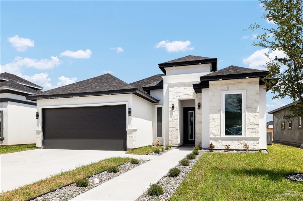 a front view of a house with a yard and garage