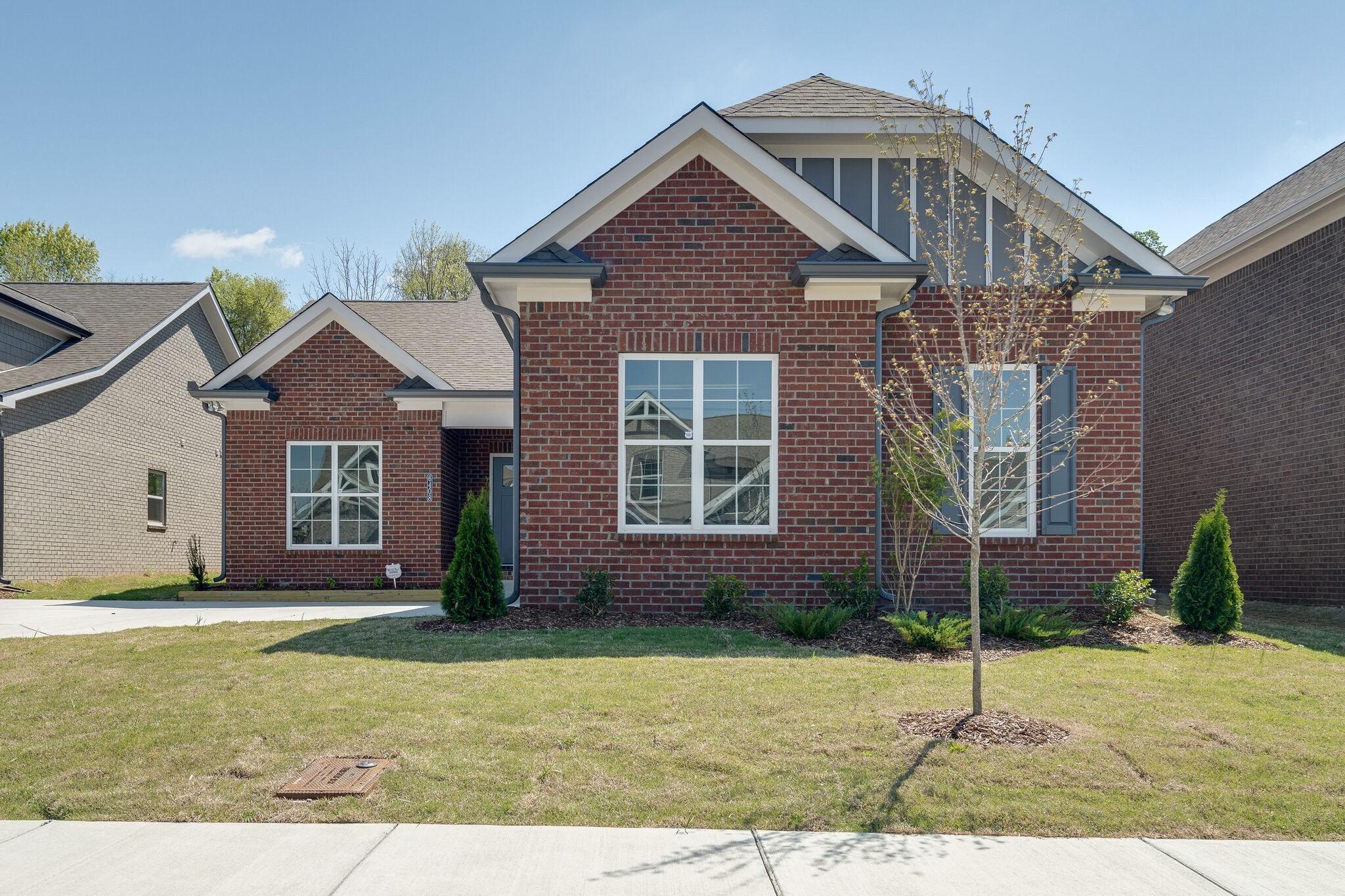 a front view of a house with a garden