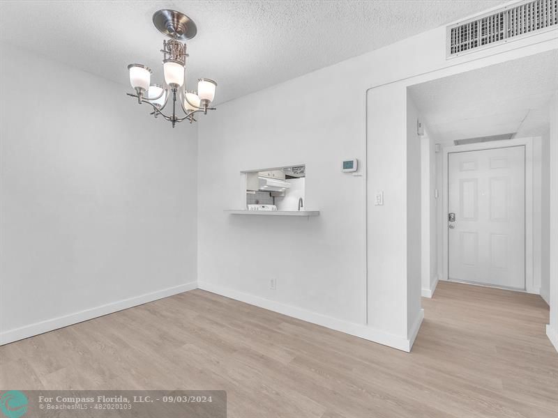 a view of a chandelier fan and wooden floor