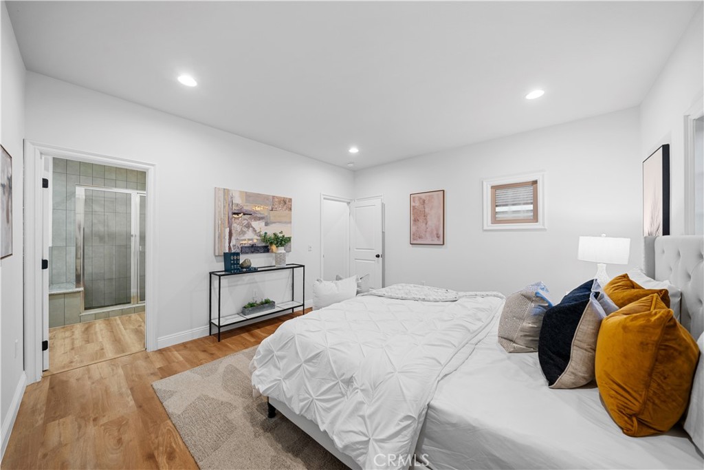 a bedroom with a bed and a painting on the wall