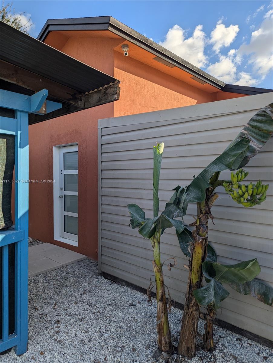 a backyard of a house with table and chairs