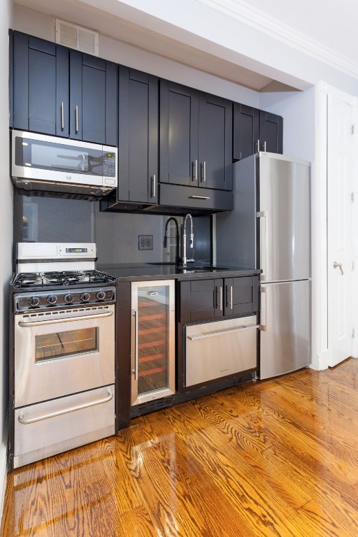 a kitchen with stainless steel appliances a stove a refrigerator and cabinets