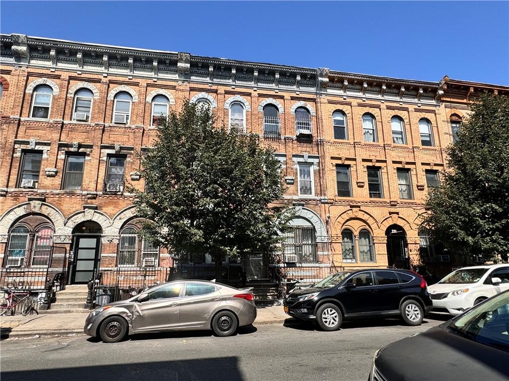 a couple of cars parked in front of a building