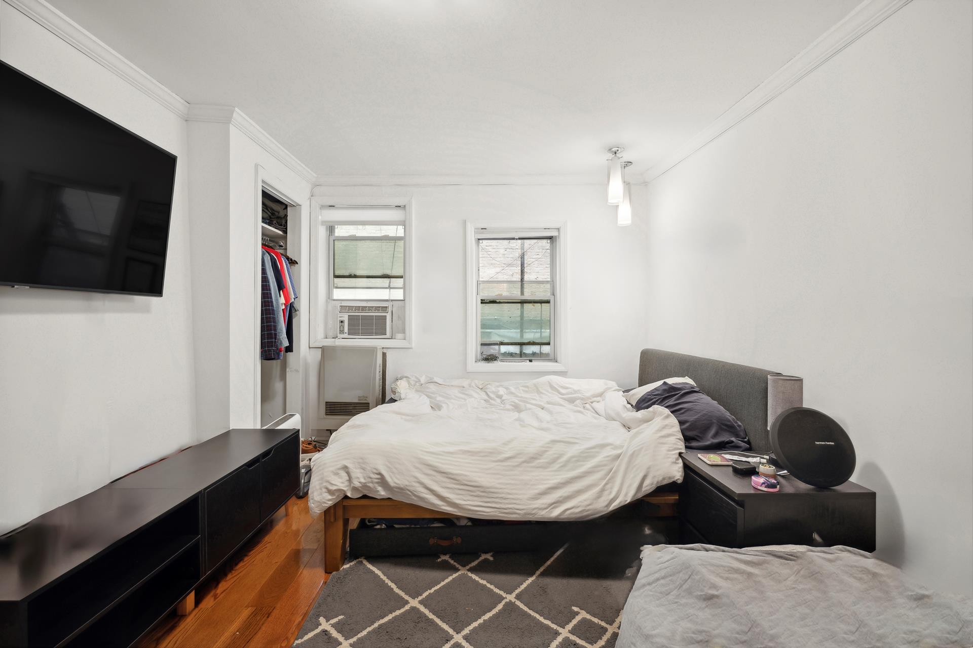 a bed room with a bed and a television