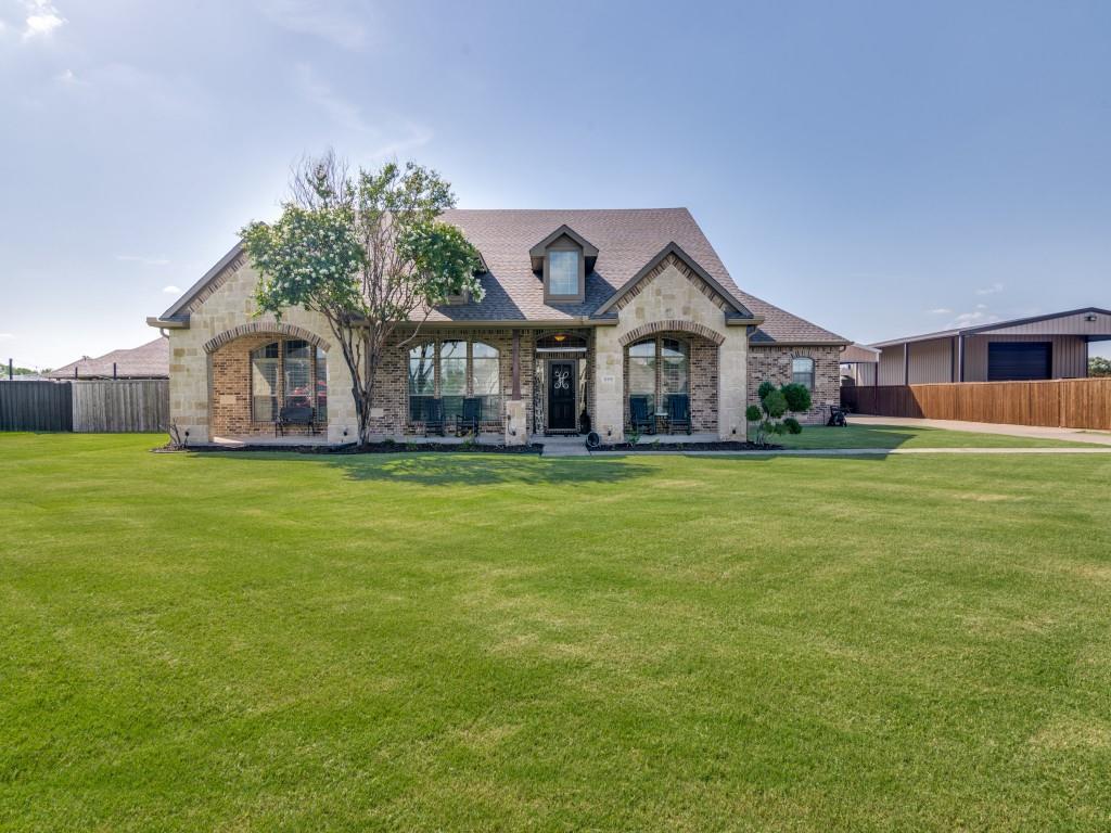 a front view of house with yard and green space