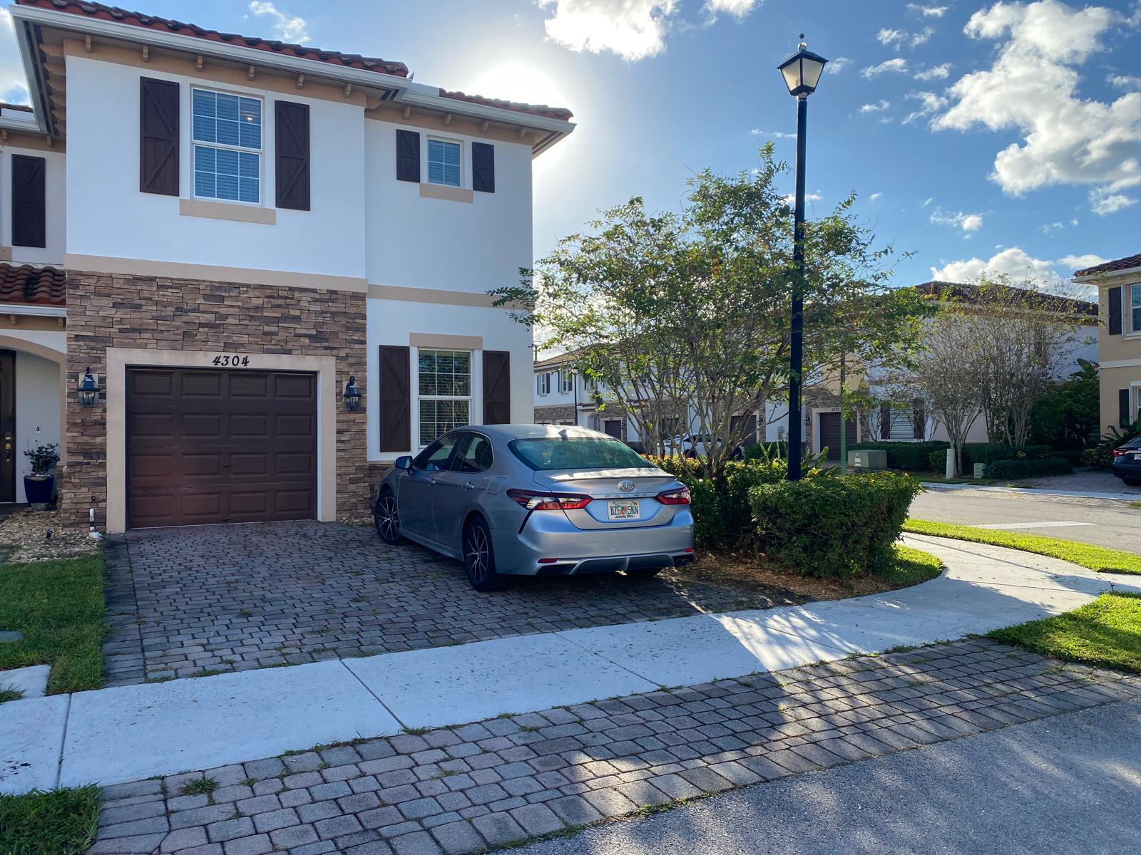 a front view of a house with swimming pool having outdoor seating