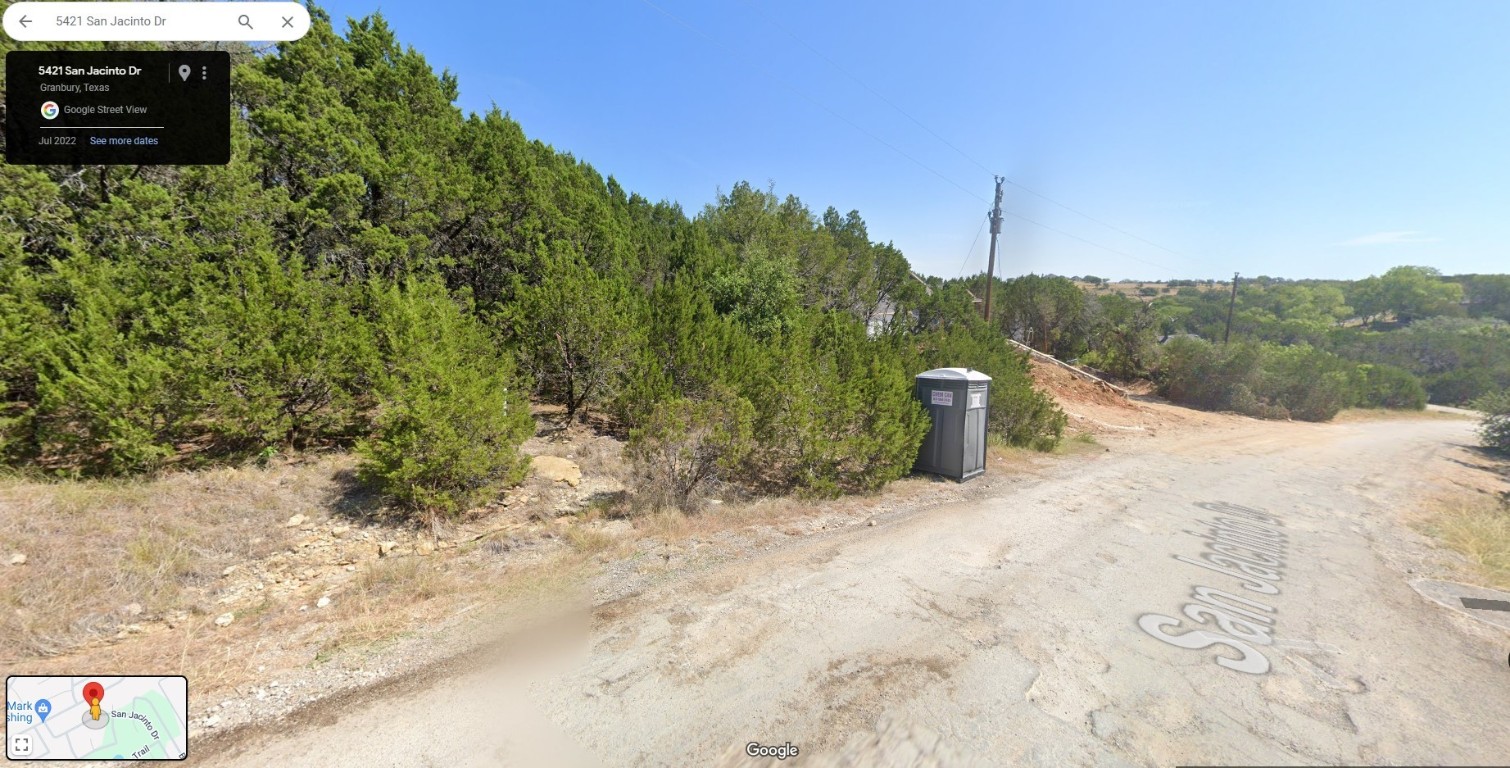 a view of a pathway with a yard