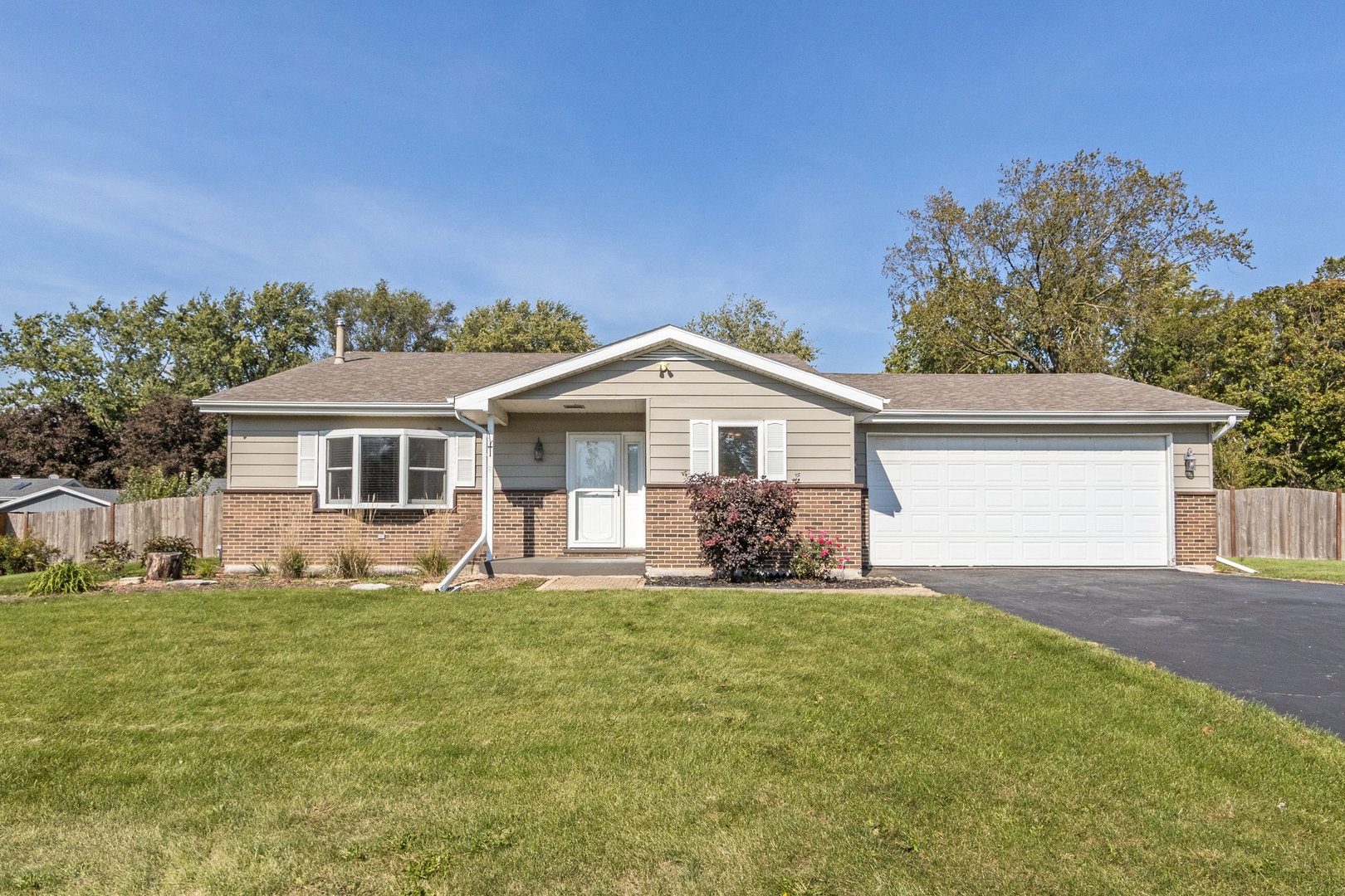 a front view of house with yard and green space