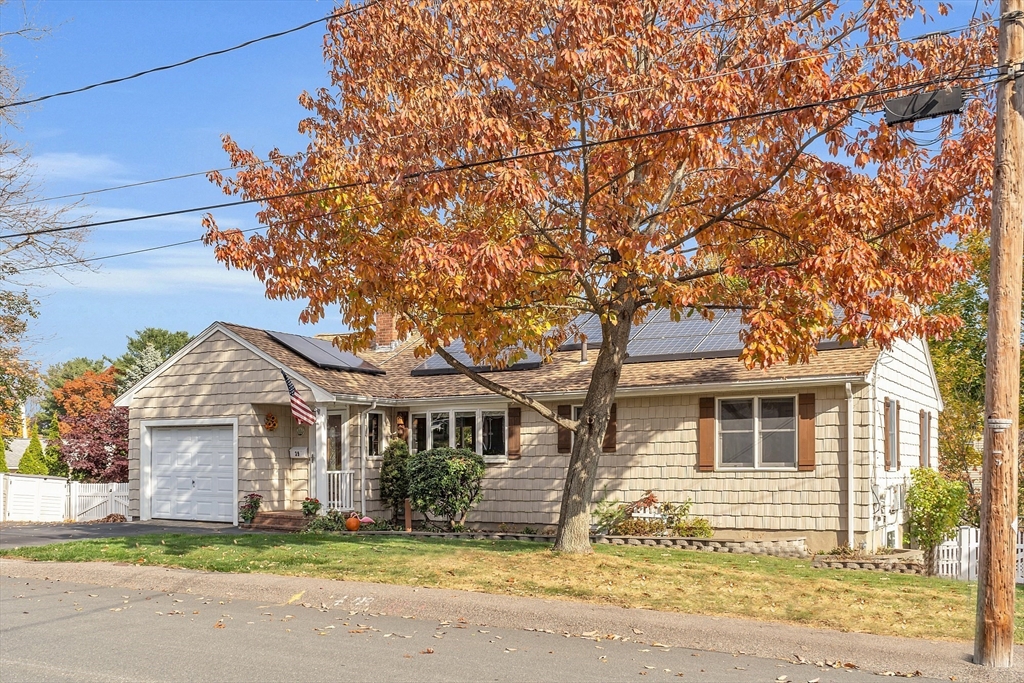 a front view of a house with a garden