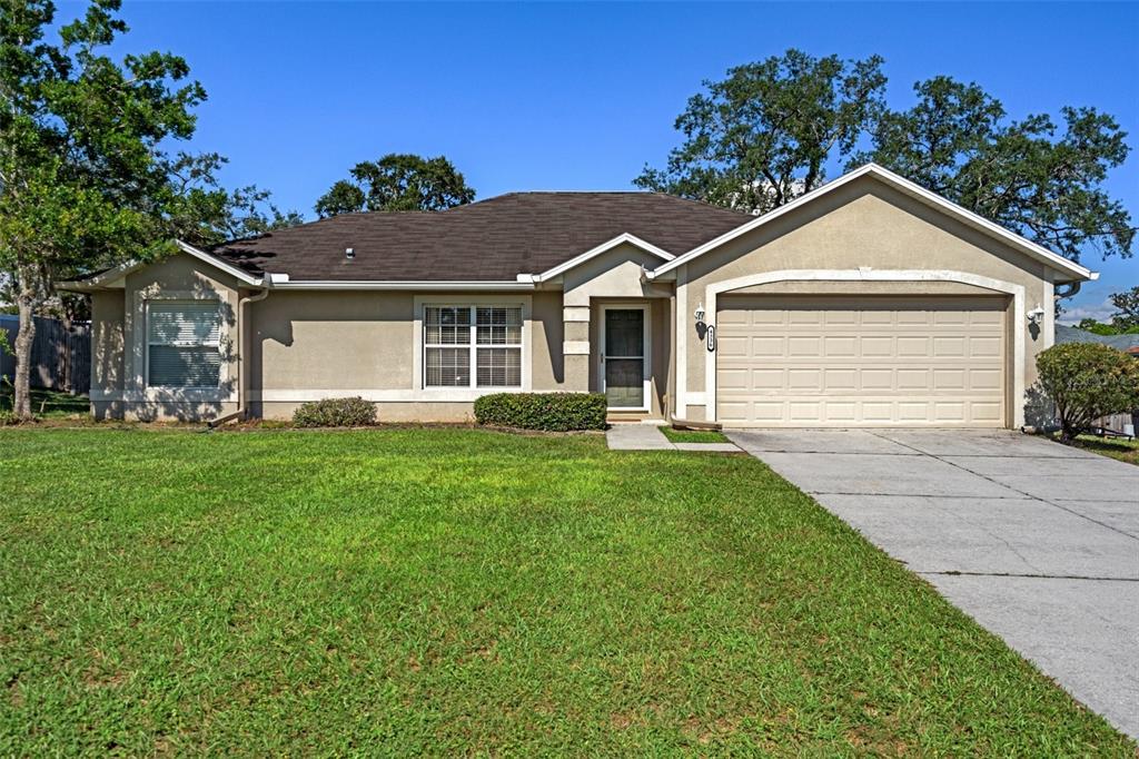 a front view of house with yard and green space