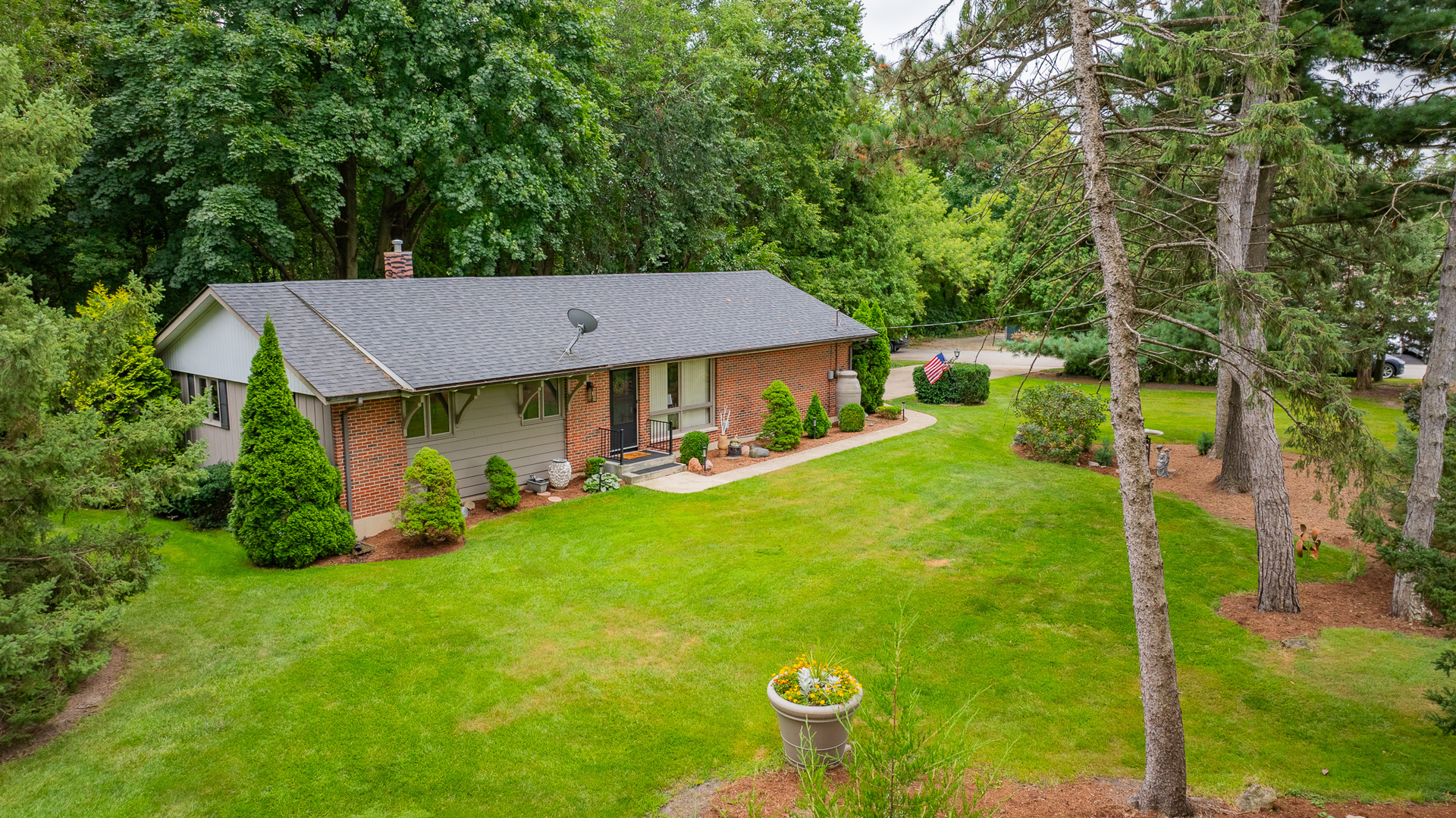 a view of an house with backyard space and garden