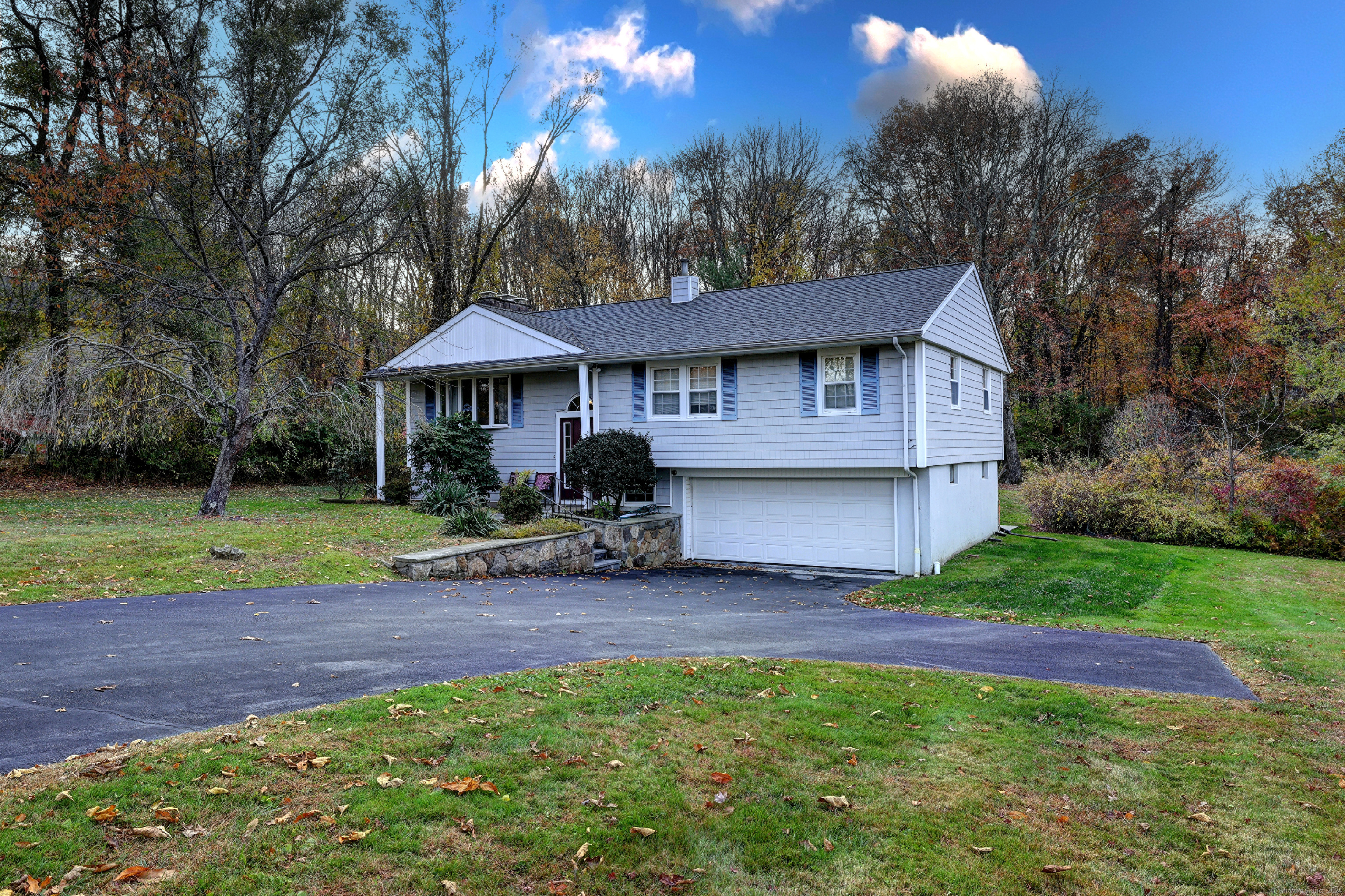 a view of a house with a yard and sitting area