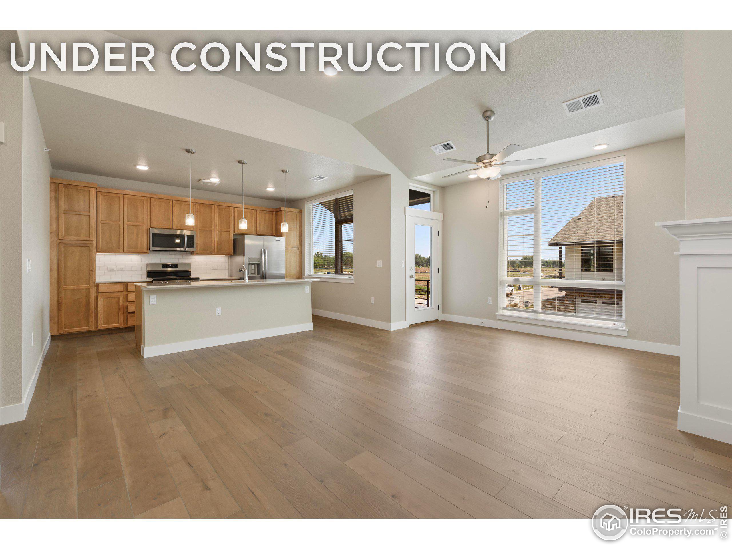 a kitchen with stainless steel appliances kitchen island a refrigerator and a sink