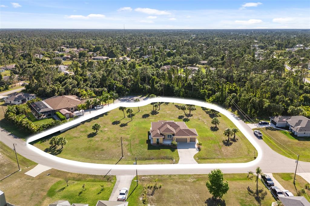 an aerial view of a house with swimming pool