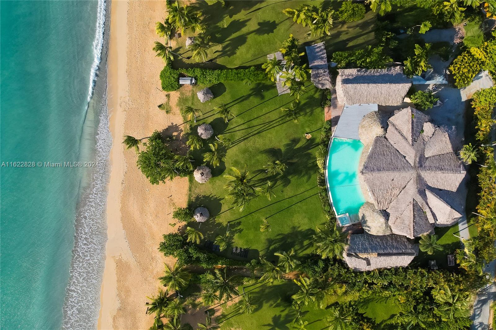 an aerial view of a house with a yard and garden