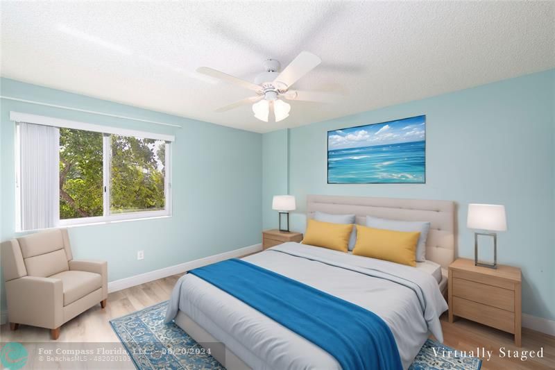 a bedroom with a large bed couch and a window