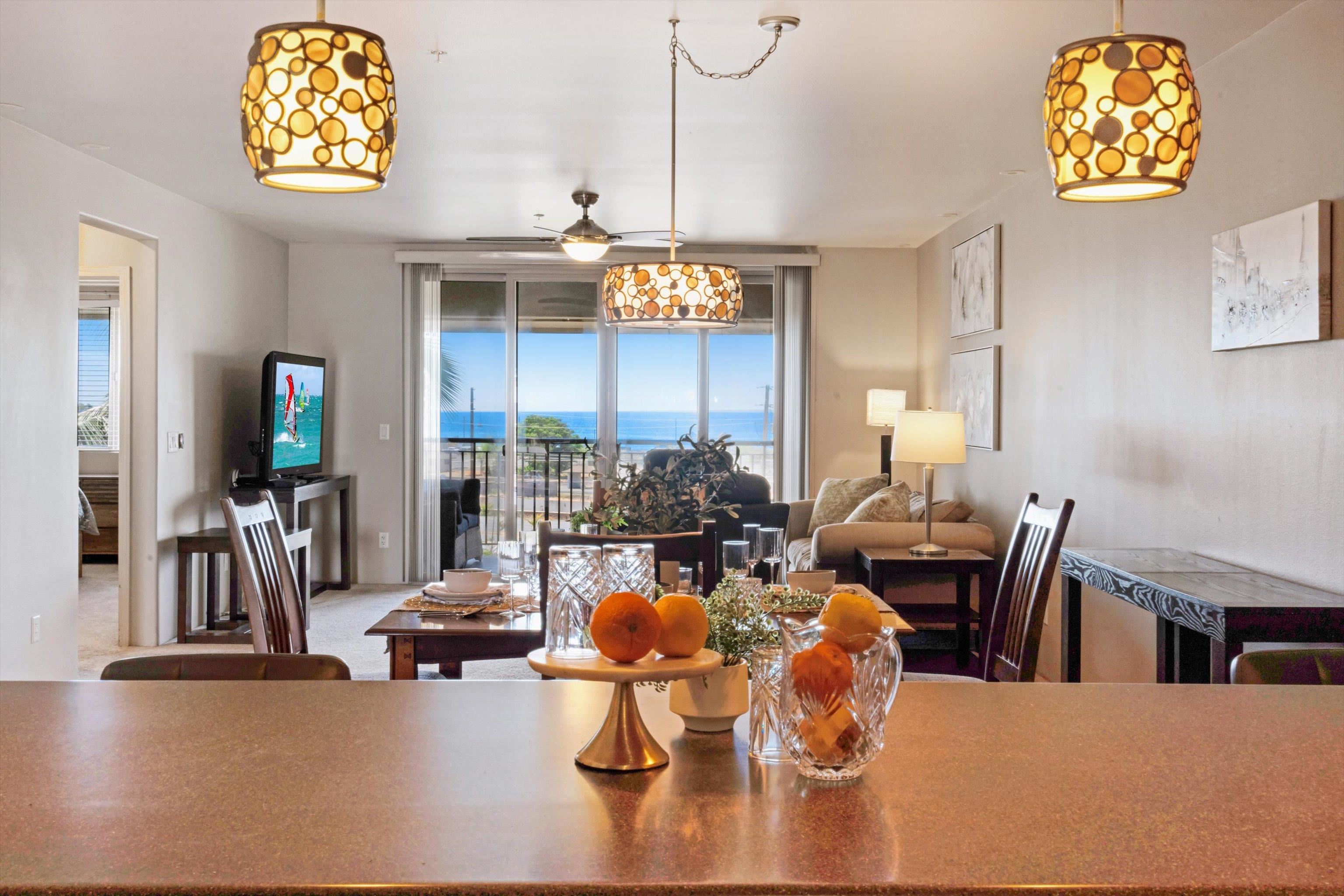 a dining room with furniture a chandelier and wooden floor