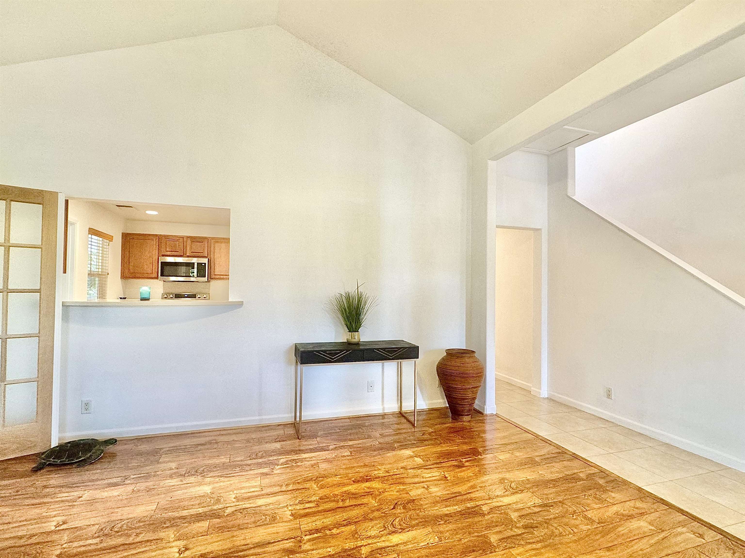 a view of a bedroom with a bed and wooden floor