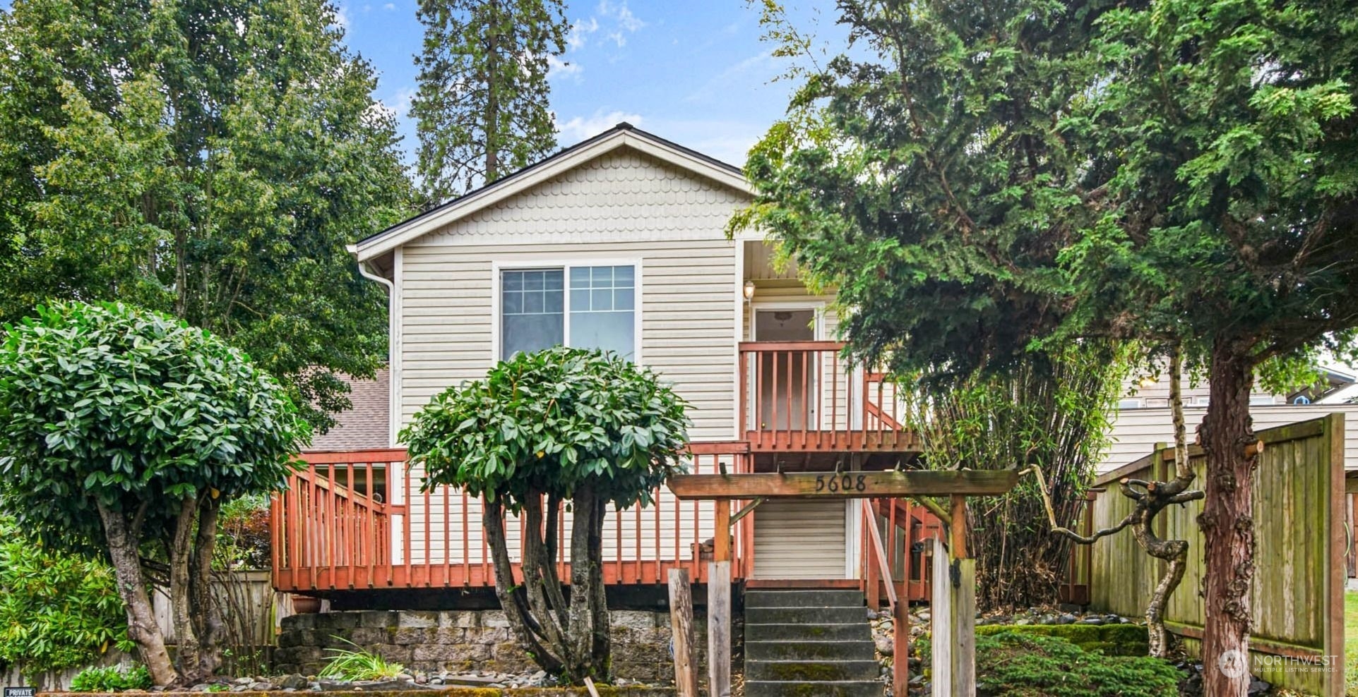 a house that has a tree in front of the house