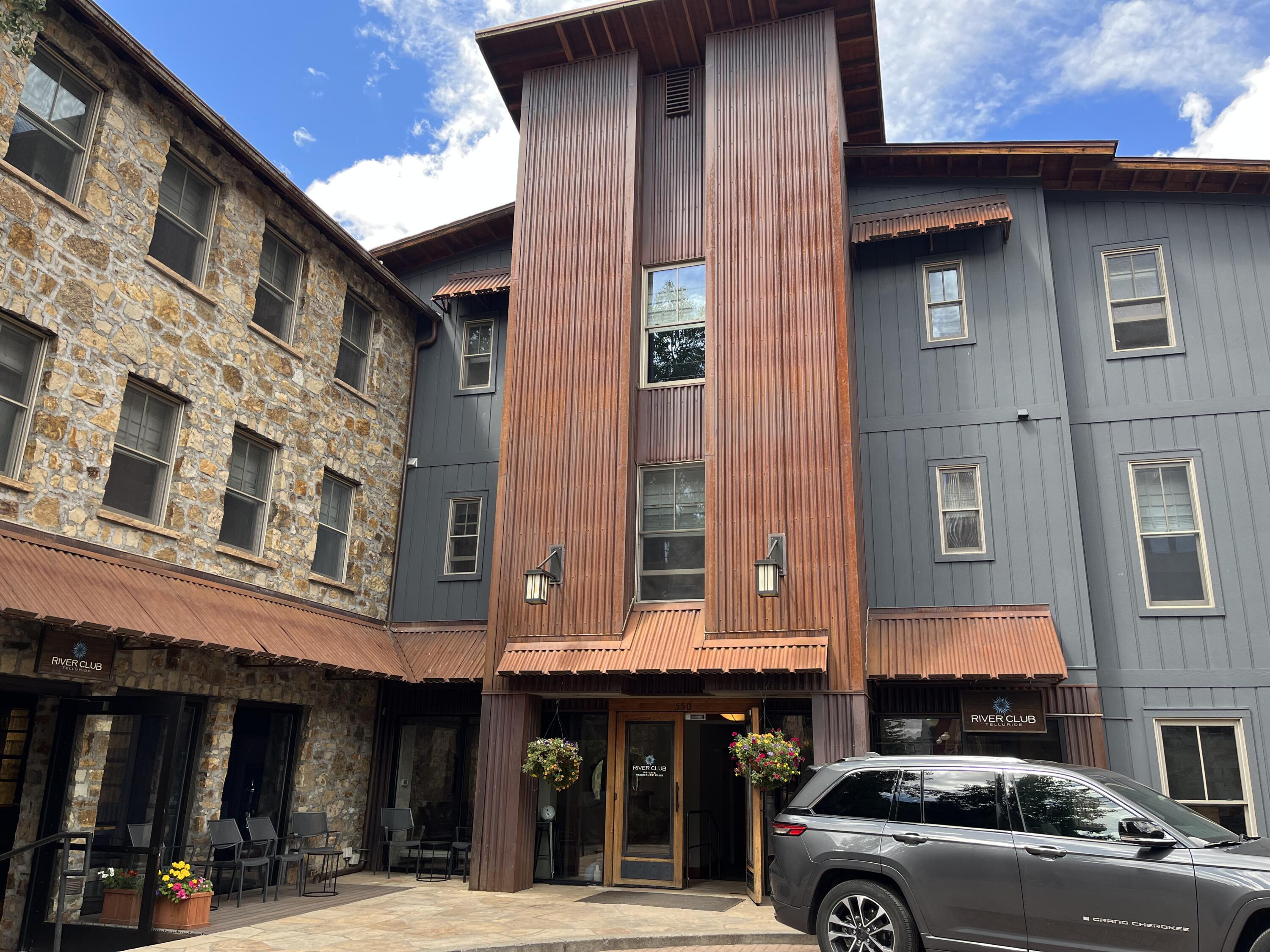 a view of a building with car parked