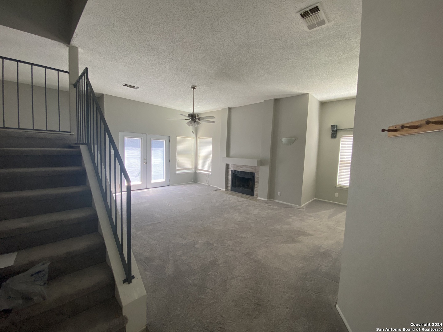 wooden floor in an empty room with a fireplace