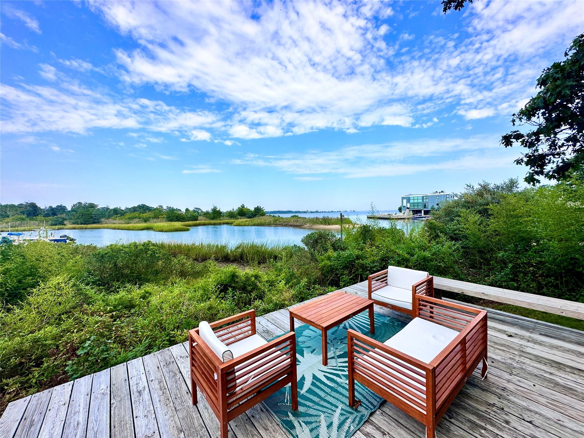 a view of a roof deck with hardwood and lake view